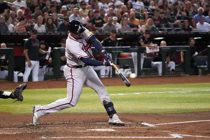 Jun 3, 2023; Phoenix, Arizona, USA; Atlanta Braves third baseman Austin Riley (27) hits a sacrifice fly RBI against the Arizona Diamondbacks during the third inning at Chase Field. Mandatory Credit: Joe Camporeale-USA TODAY Sports